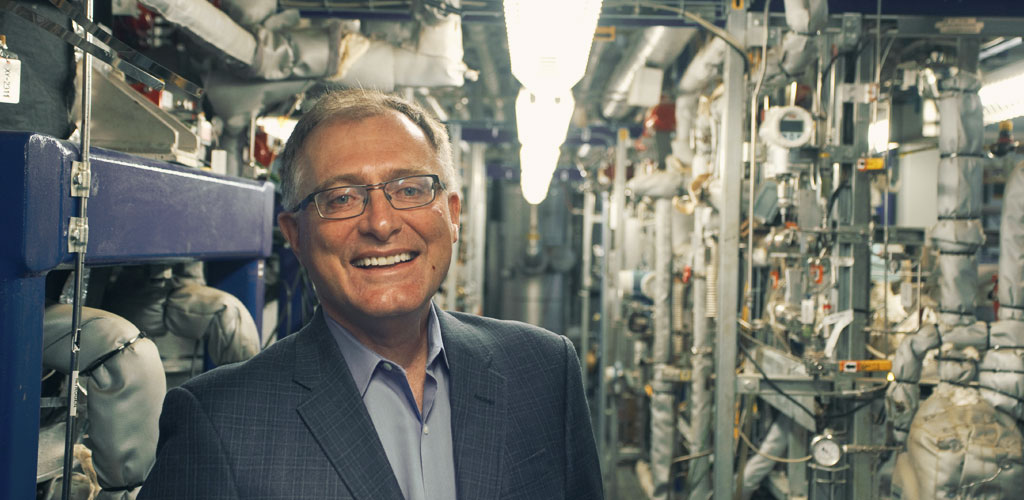 Field Upgrading President and CEO Neil Camarta stands in front of equipment at the10-barrel-per-day partial upgrading facility in Fort Saskatchewan.