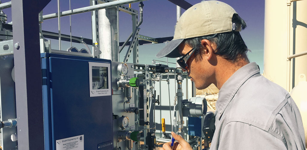 A pilot crew member from New Sky energy takes measurements from a work site.